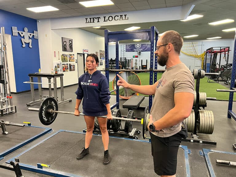 Tucson Strength personal training. Male personal trainer with female client doing deadlifts.